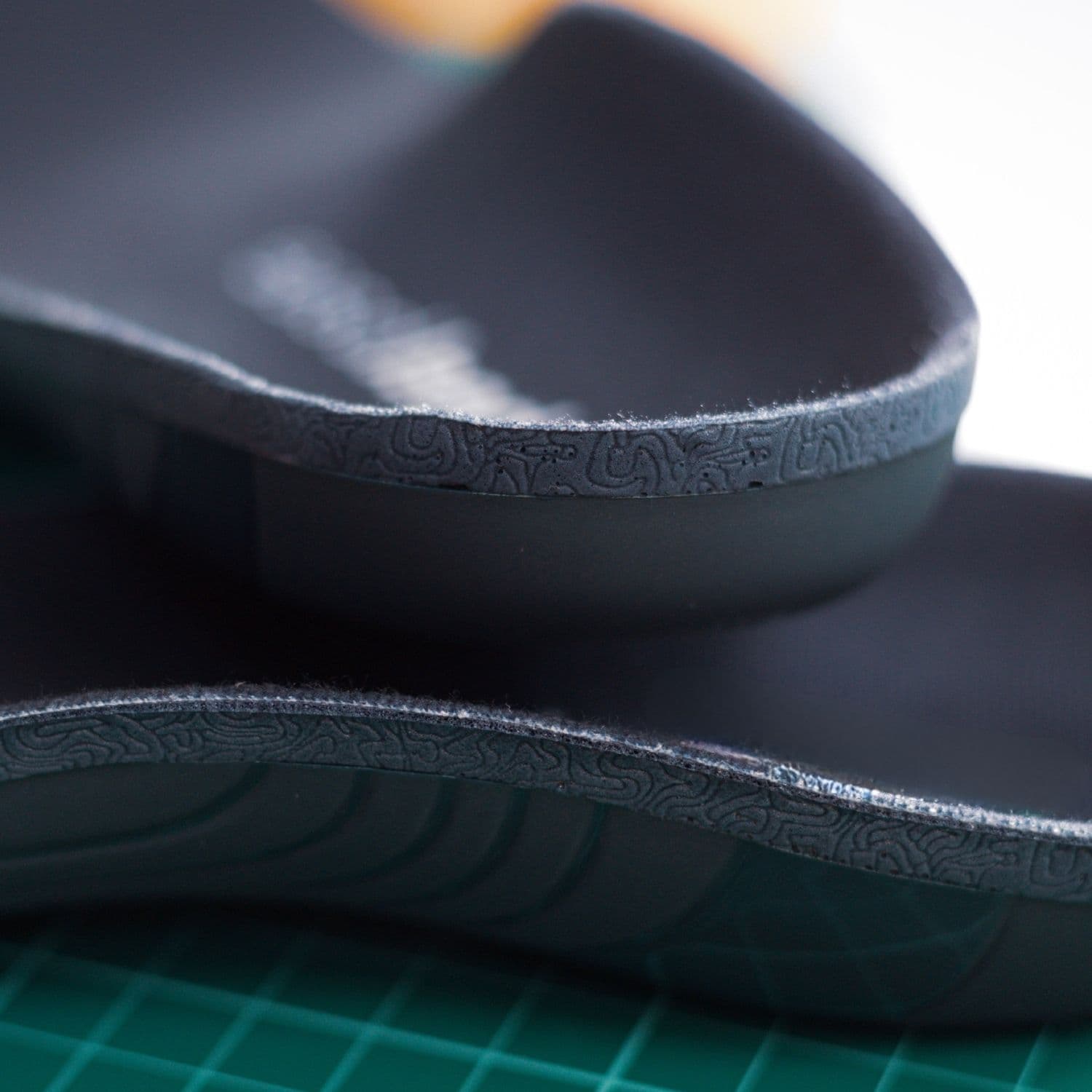 Close-up of the deep heel cup on two HeelBase Apex insoles