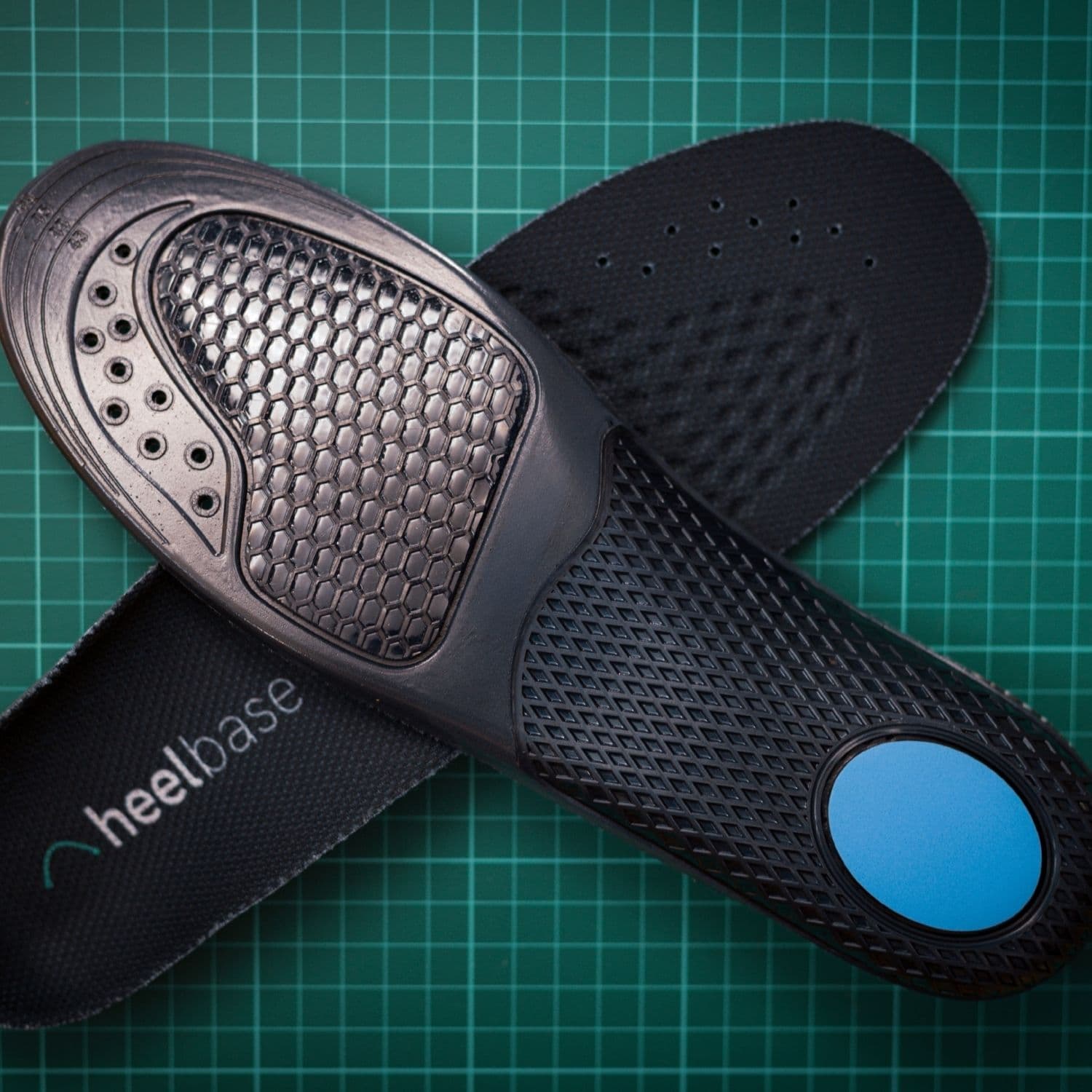 Overlapping top and underside views of HeelBase Stance insoles showing the structural base