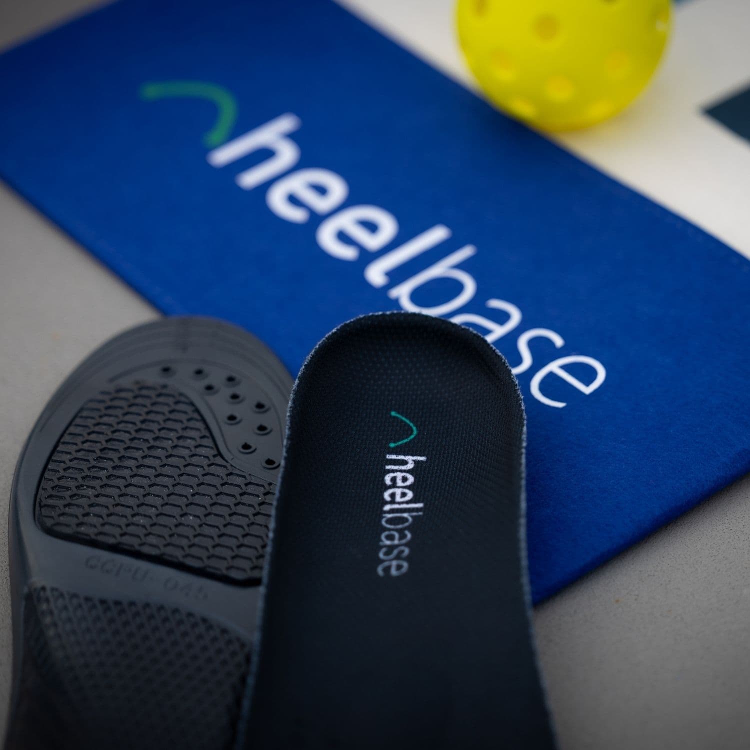 HeelBase Stance heel construction displayed with branded pickleball equipment