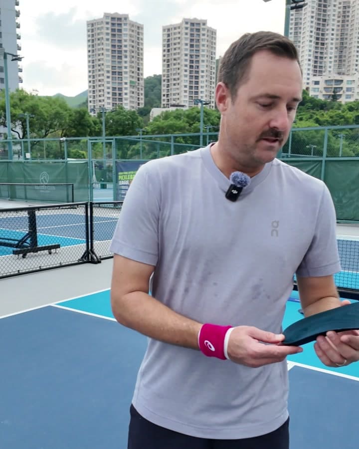 Pete M. holding HeelBase Drive insoles on a pickleball court