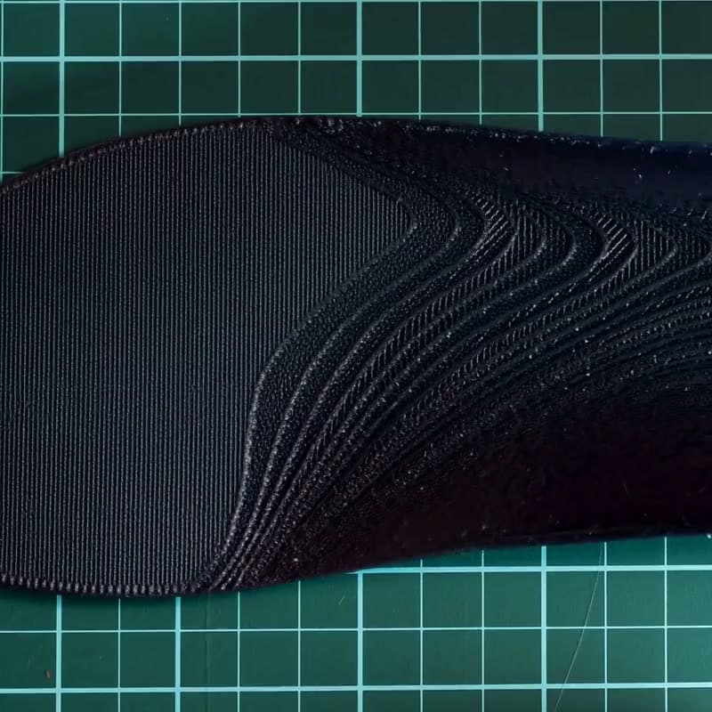 Studio close-up moving along the printed arch and HeelBase logo on a Drive insole