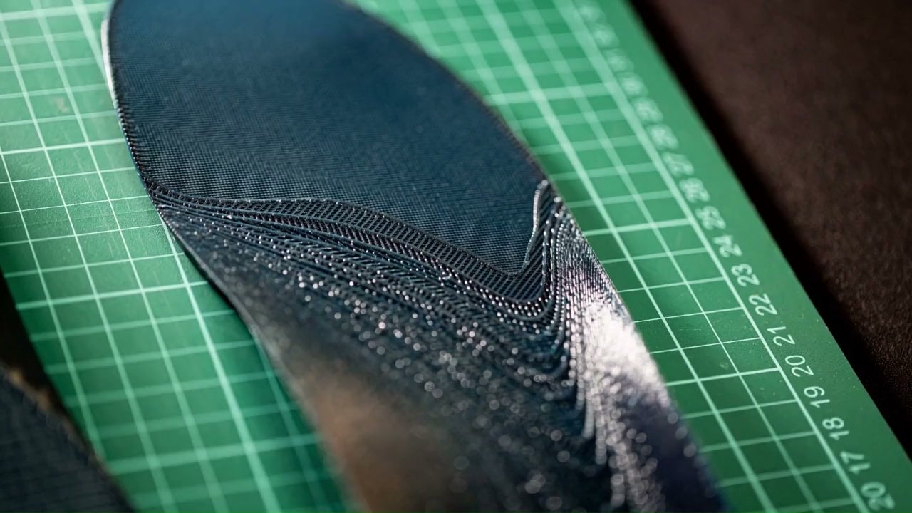 Two HeelBase Drive pickleball insoles positioned on an engineering measurement grid
