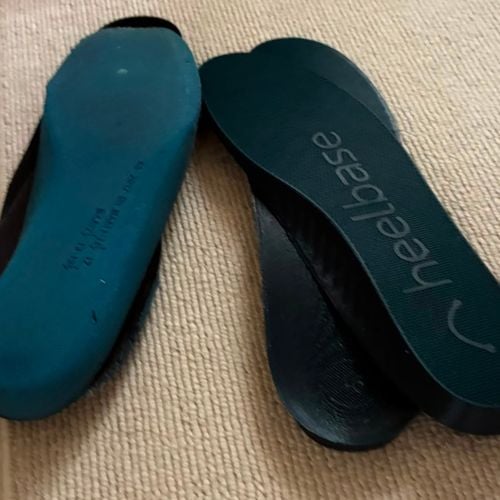 Customer photo showing the top and bottom of HeelBase Drive insoles next to old insoles