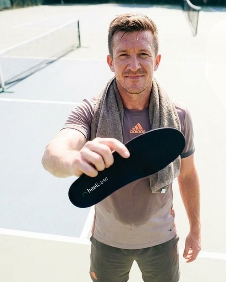Paul holding a HeelBase Apex insole outdoors