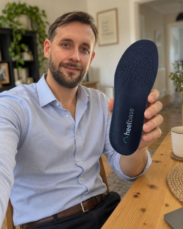 Steve holding a HeelBase Stance insole indoors