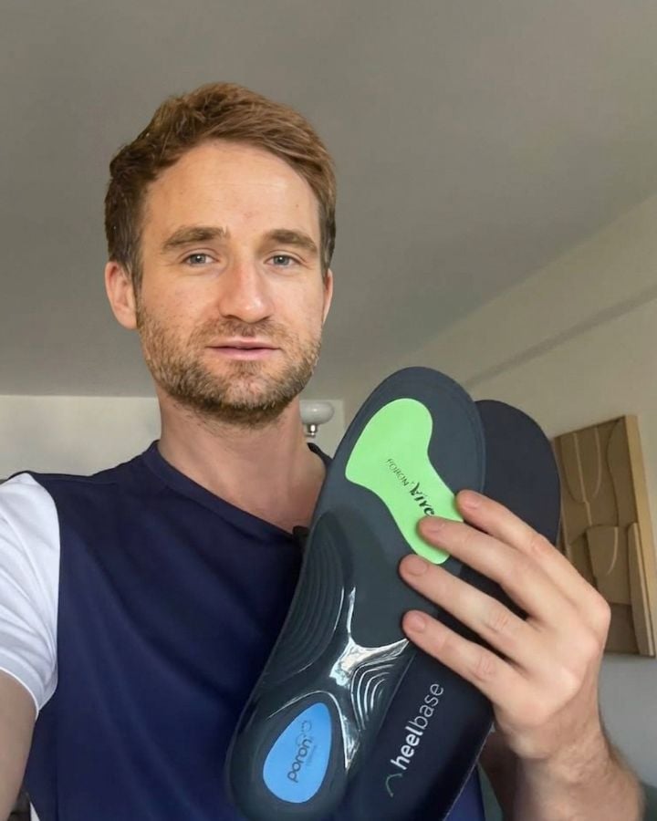 Tom holding a pair of HeelBase Apex insoles
