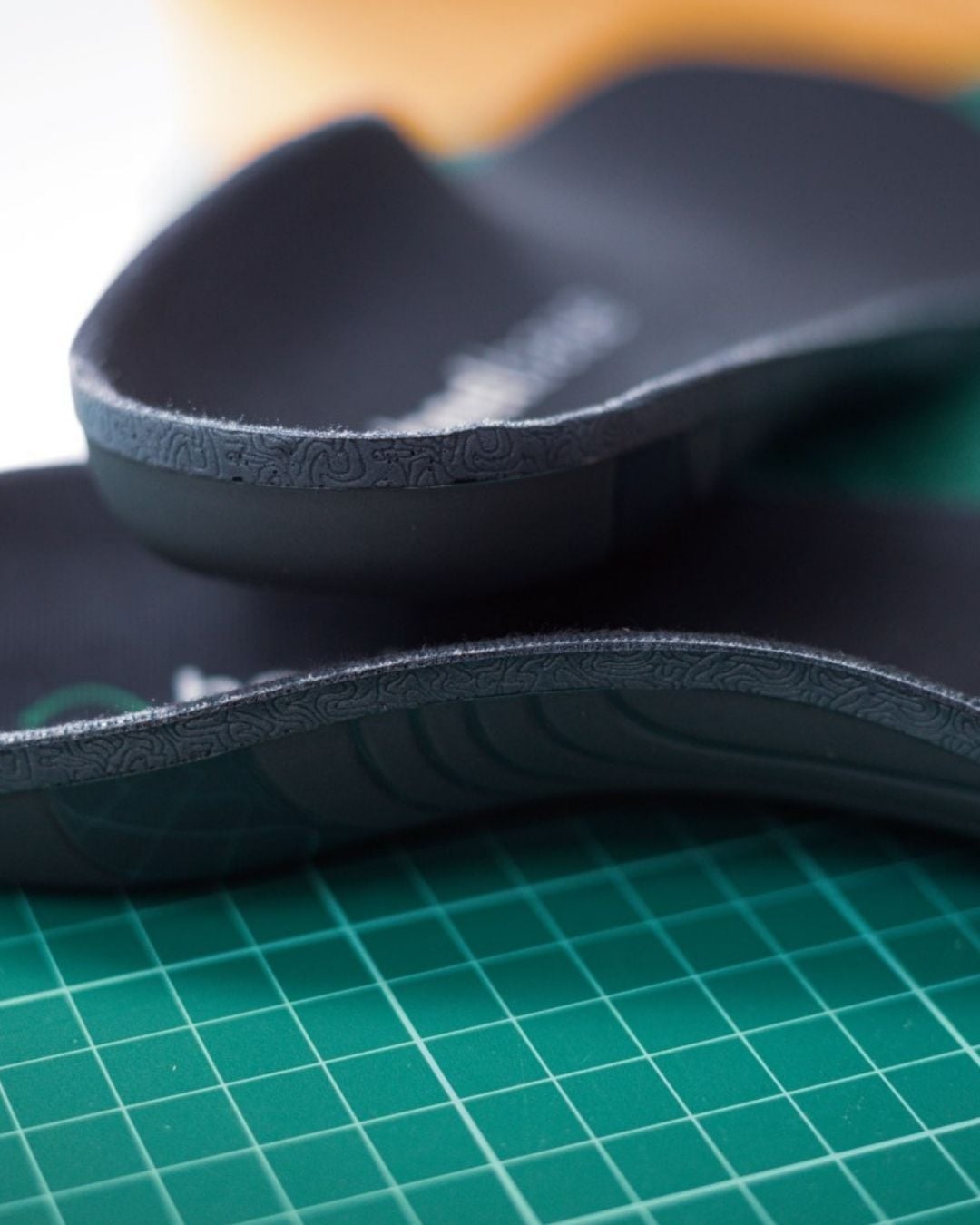 Close-up of HeelBase Apex insoles showing the heel cup and support structure