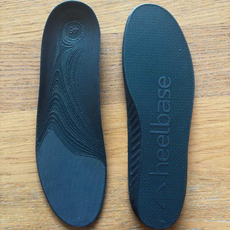 Customer photo of a pair of HeelBase Drive insoles on a wooden floor